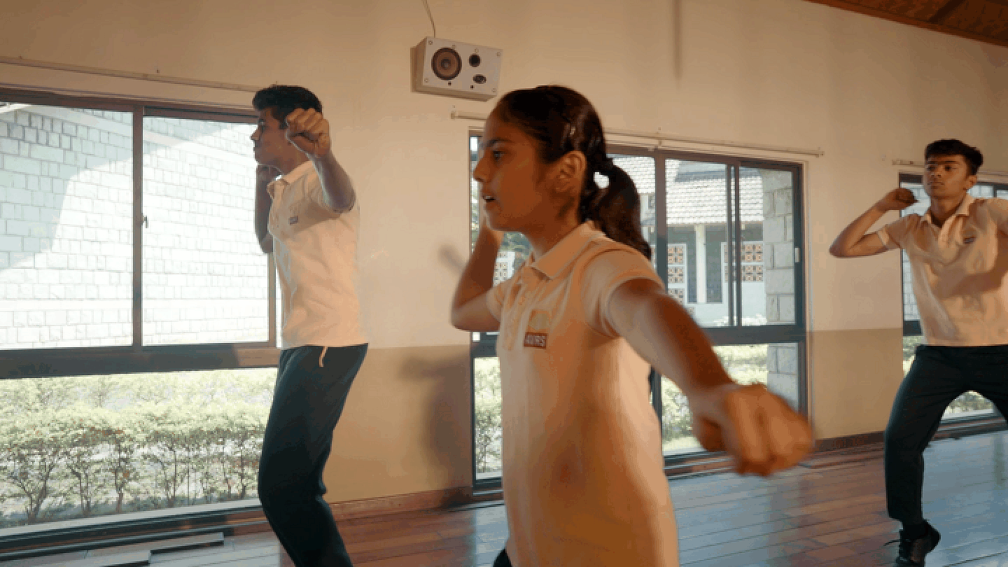 Students practicing dance and movement in the studio