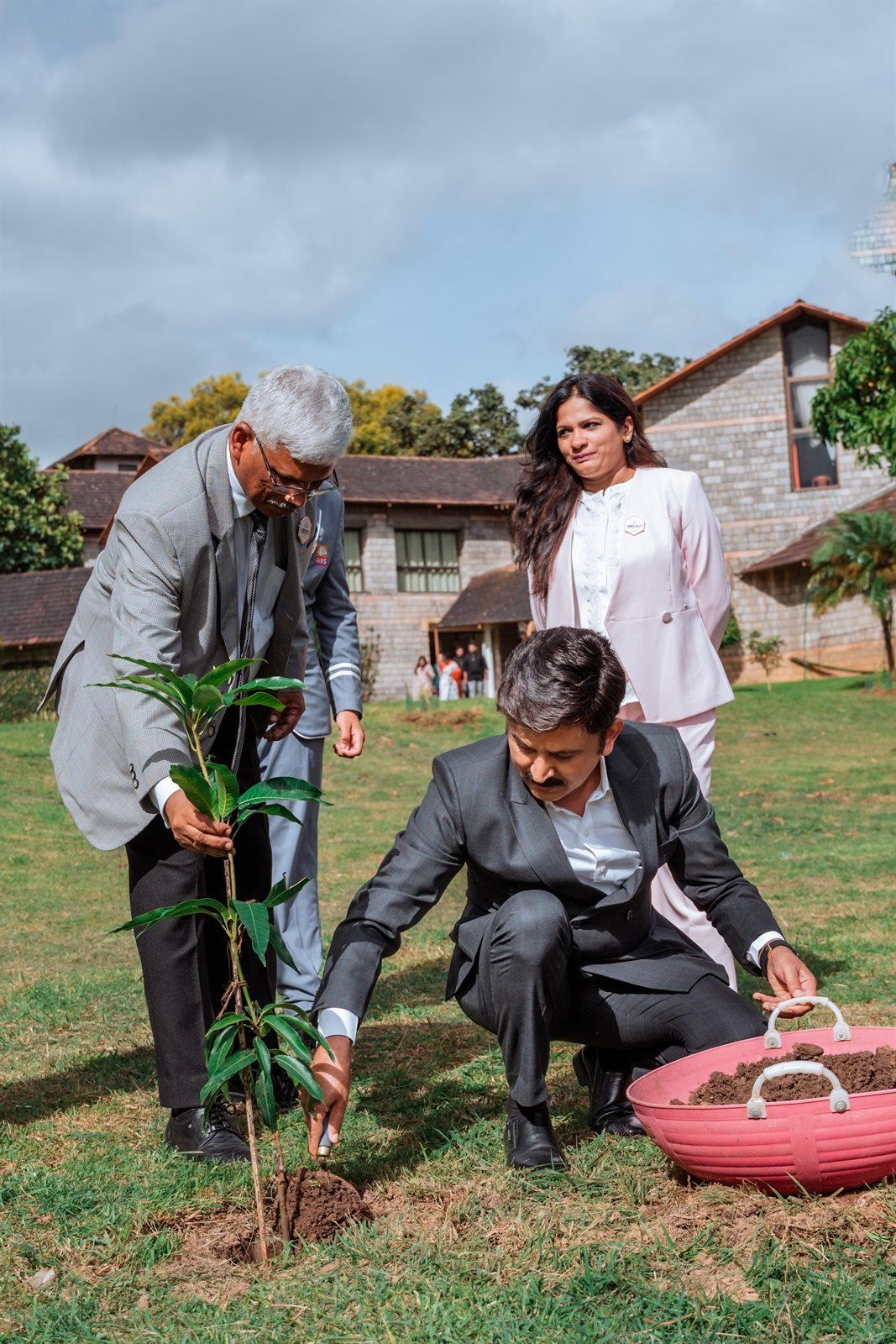 Chief Guest Ramesh Aravind planting sapling on Amber Valley campus grounds